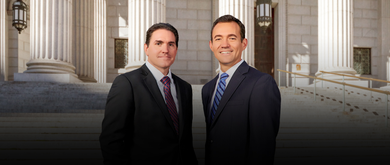 Group photo of Lasnetski Gihon Law and a white building with columns in the background